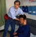 Chinacal volunteer Sonny Kan examines patient